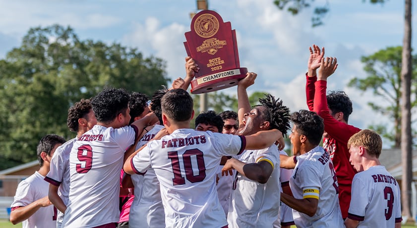 Soccer team celebrates with trophy